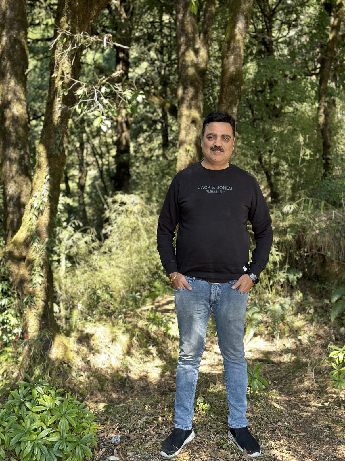 Gaurav Ghulati standing on a forest trail.
