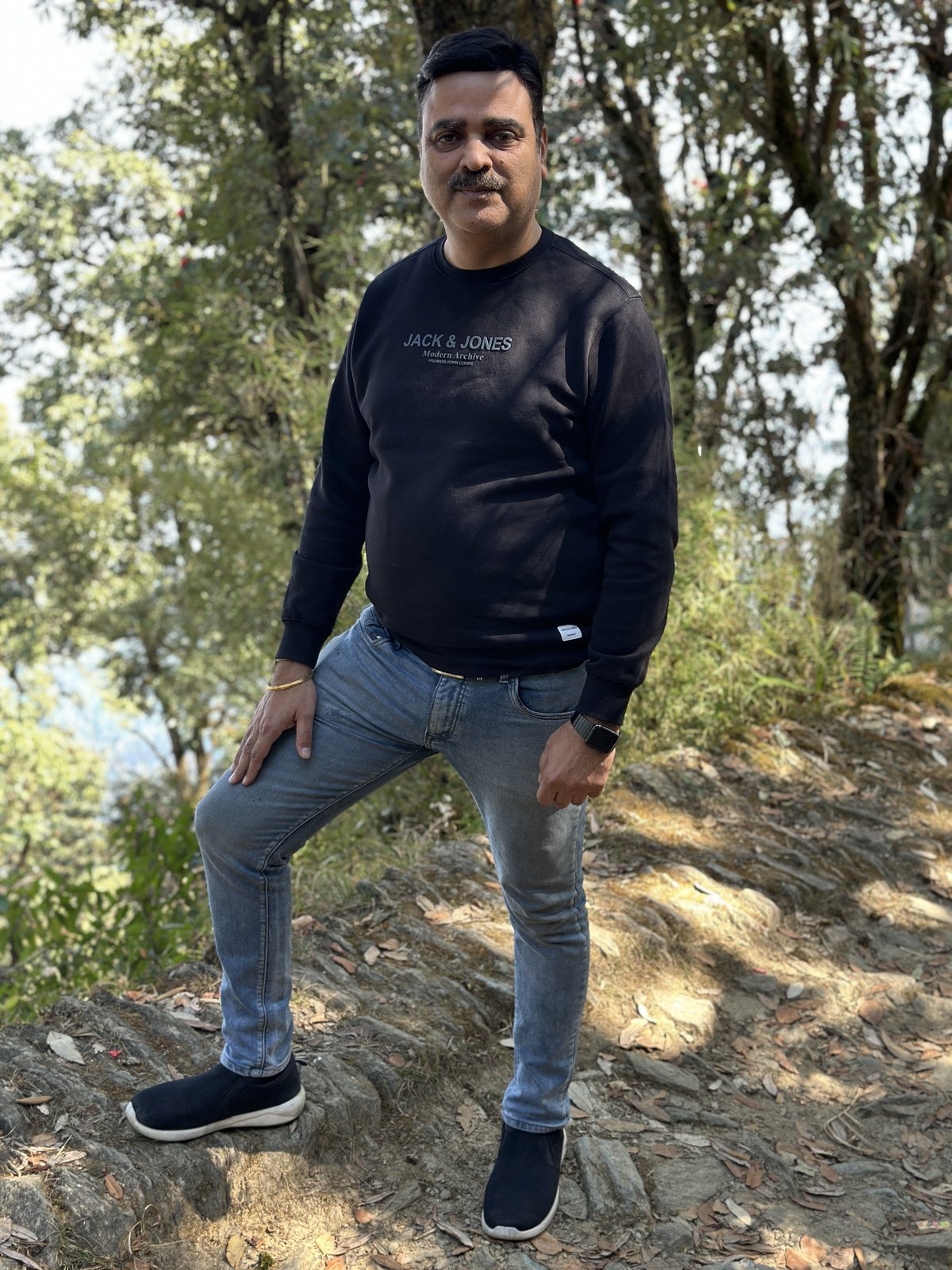 Gaurav Ghulati standing near a wooded hillside view.