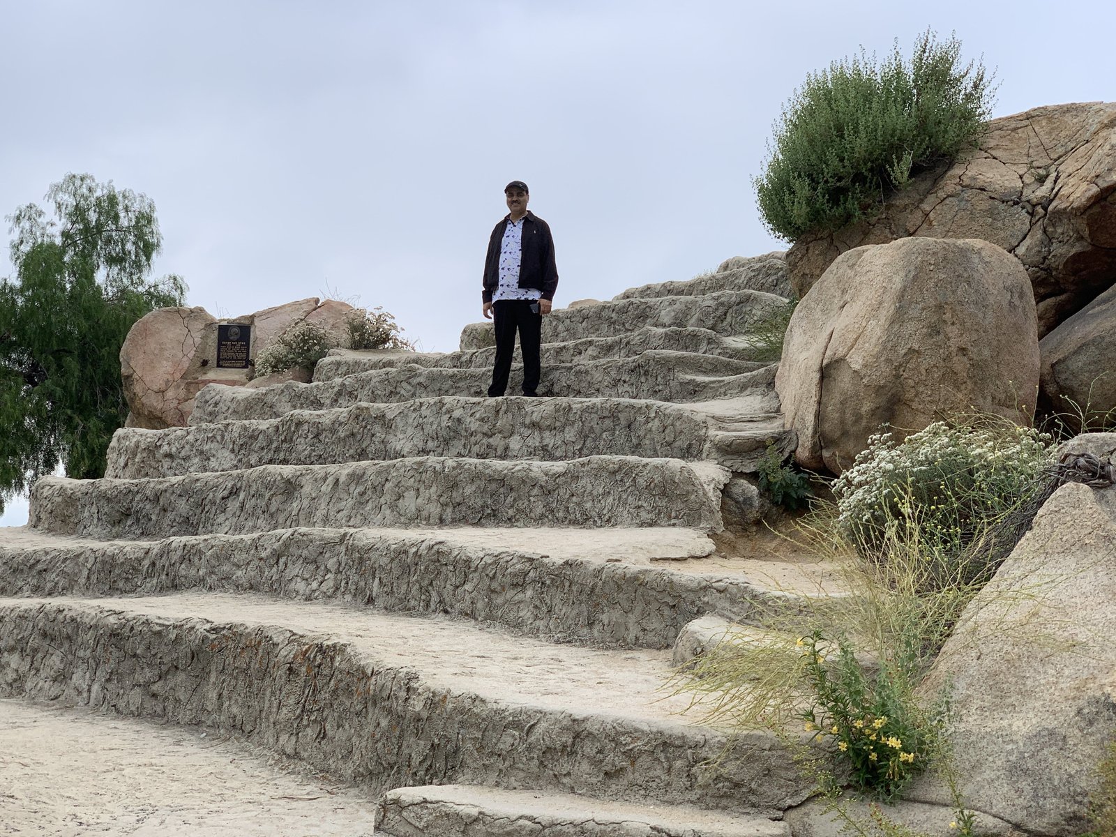 Gaurav Ghulati standing on stone steps during an outdoor walk.