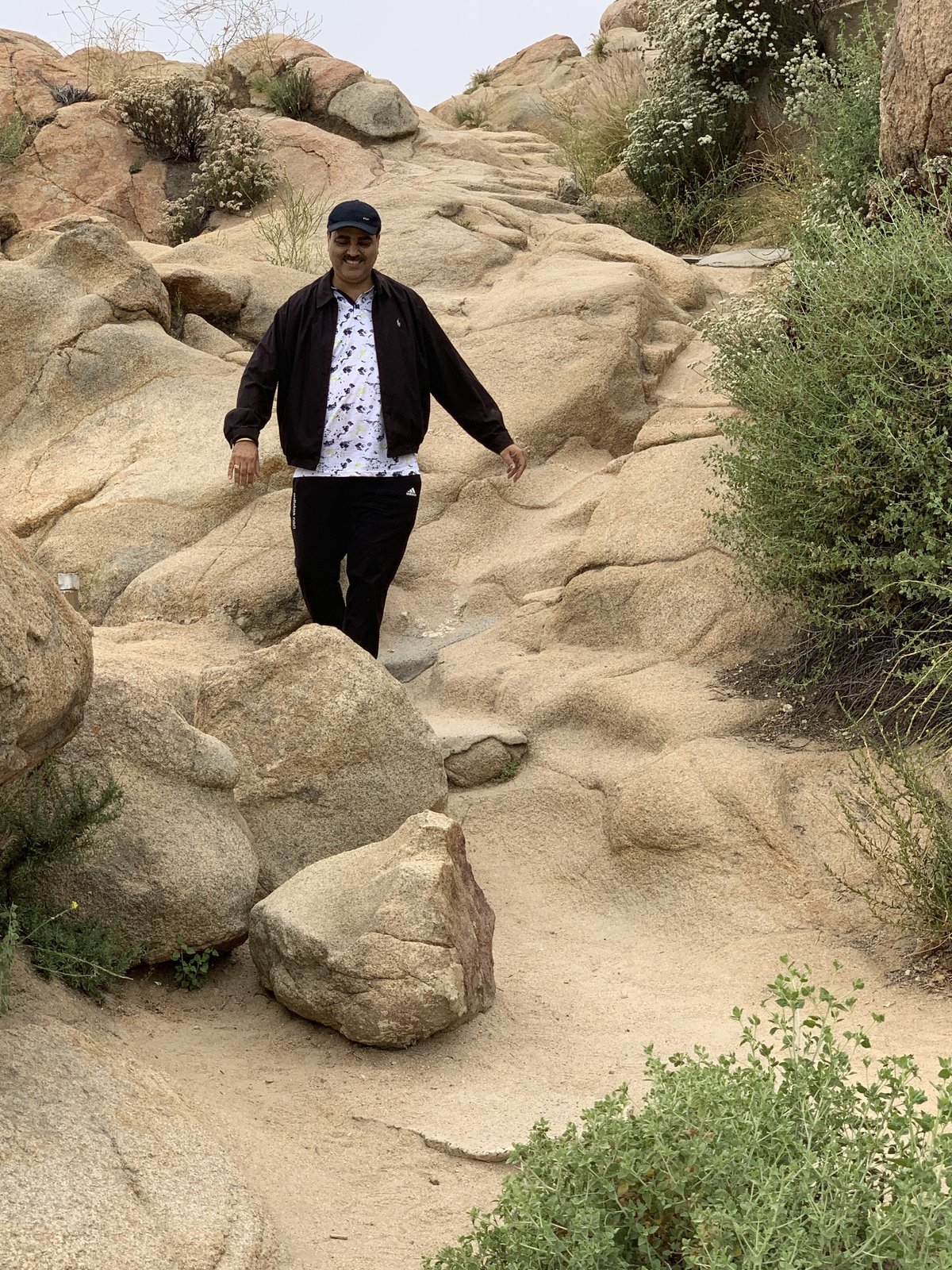 Gaurav Ghulati walking through a rocky outdoor trail.