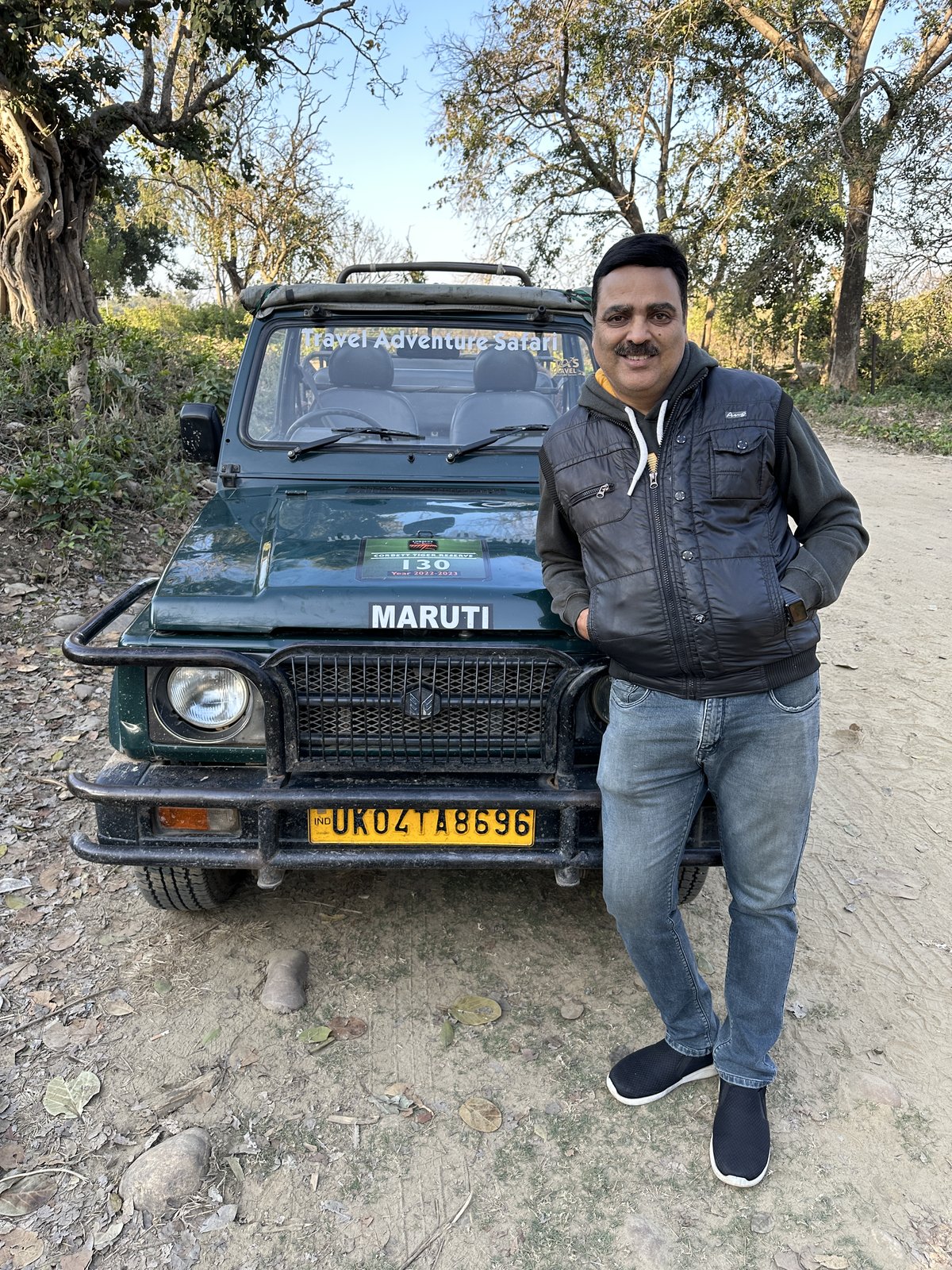 Gaurav Ghulati standing beside a classic Maruti vehicle.